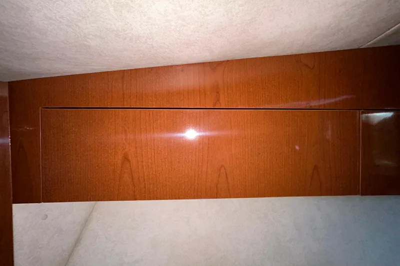 Slide: The Image of Interior compartment of a 2012 Sea Ray Sundancer 310 boat, showing storage area details. - 180