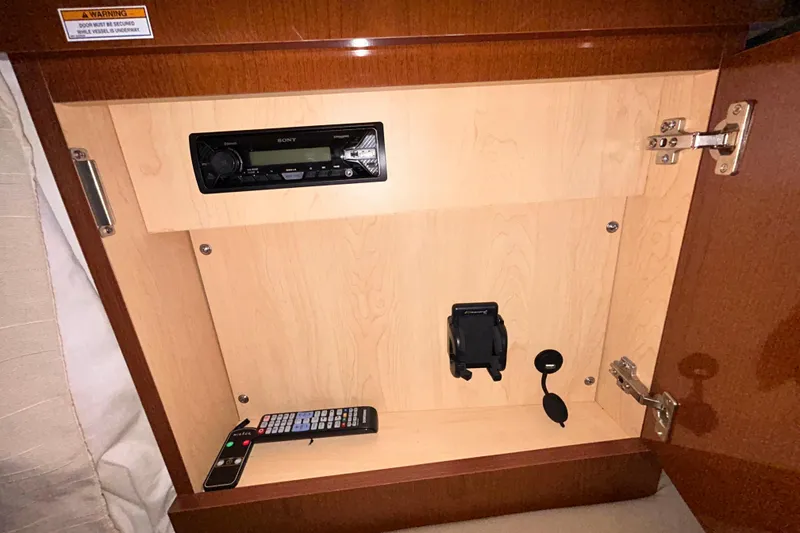 Slide: The Image of Interior cabin of 2012 Sea Ray Sundancer 310, featuring wood paneling and cozy design. - 188