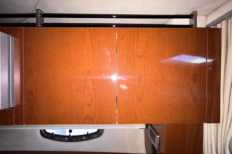 Slide: The Image of Interior cabin view of a 2012 Sea Ray Sundancer 310 yacht with a window and curtain. - 189