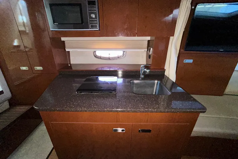 Slide: The Image of Engine compartment of a 2012 Sea Ray Sundancer 310 with visible copper piping and components. - 193