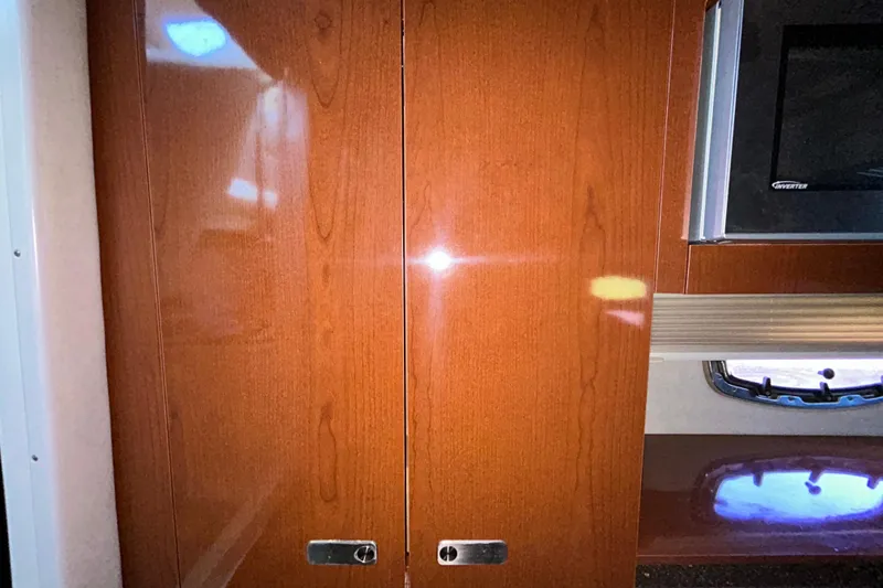 Slide: The Image of Wooden storage compartment inside a 2012 Sea Ray Sundancer 310 boat. - 196