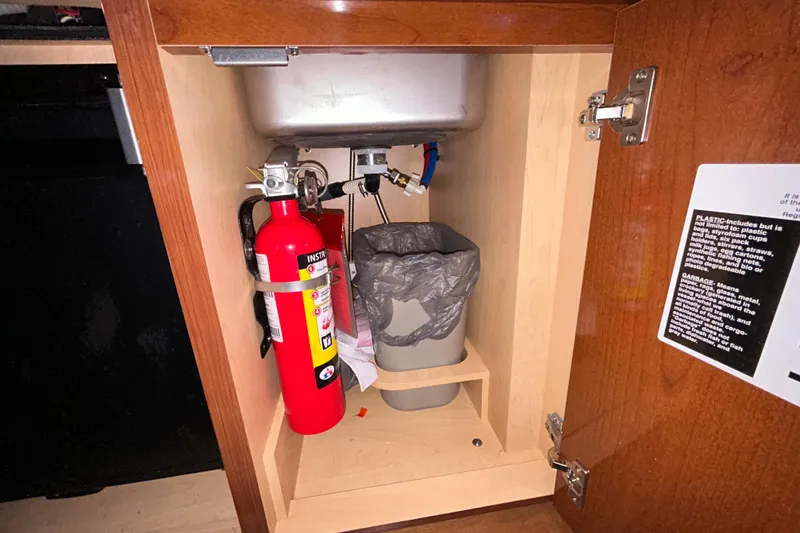 Slide: The Image of Wooden storage compartment inside a 2012 Sea Ray Sundancer 310 boat. - 200