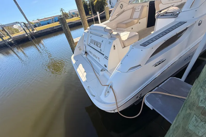 Slide: The Image of 2012 Sea Ray 310 Sundancer docked at a marina, rear view. - 24