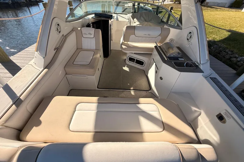 Slide: The Image of 2012 Sea Ray 310 Sundancer boat interior with beige seating and kitchenette. - 34