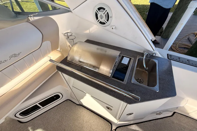 Slide: The Image of 2012 Sea Ray 310 Sundancer boat interior with kitchenette and seating area. - 39