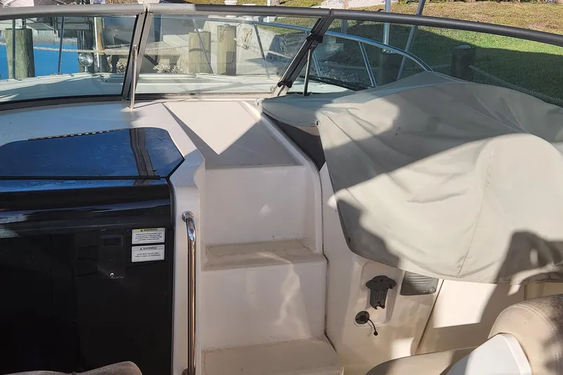 Slide: The Image of 2012 Sea Ray 310 Sundancer boat docked, rear view with dual propellers, Punta Gorda, FL. - 4