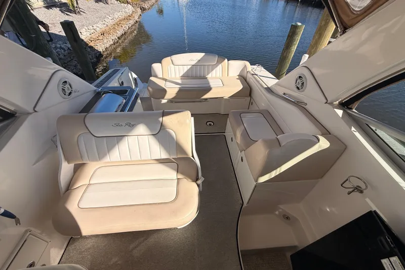 Slide: The Image of Interior of 2012 Sea Ray 310 Sundancer boat with beige seating and water view. - 42