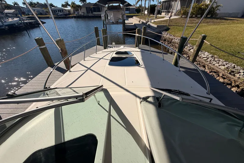 Slide: The Image of 2012 Sea Ray 310 Sundancer docked at a marina, sunny day view. - 48