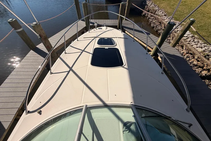 Slide: The Image of 2012 Sea Ray 310 Sundancer docked, top view of deck and railings. - 49