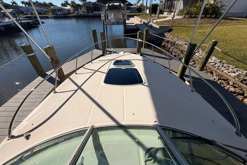 Slide: The Image of Bow view of 2012 Sea Ray 310 Sundancer docked at marina. - 52