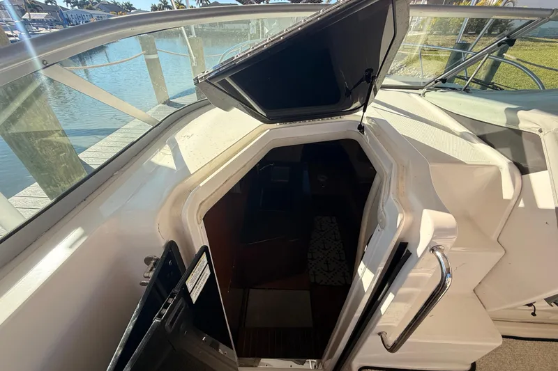 Slide: The Image of 2012 Sea Ray 310 Sundancer cabin entrance with open hatch, dockside view. - 55