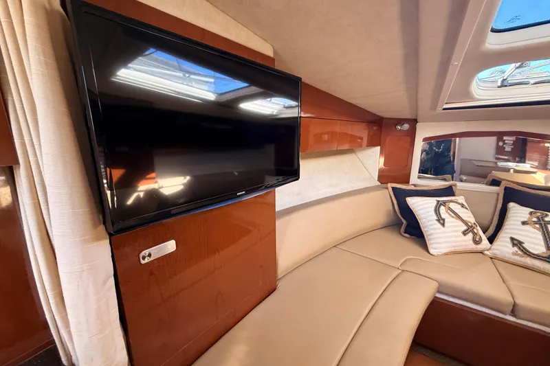 Slide: The Image of Luxurious interior of 2012 Sea Ray 310 Sundancer with TV and plush seating. - 57