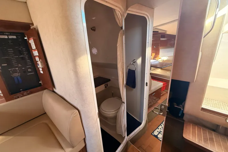 Slide: The Image of Interior of 2012 Sea Ray 310 Sundancer showing bathroom and seating area. - 63