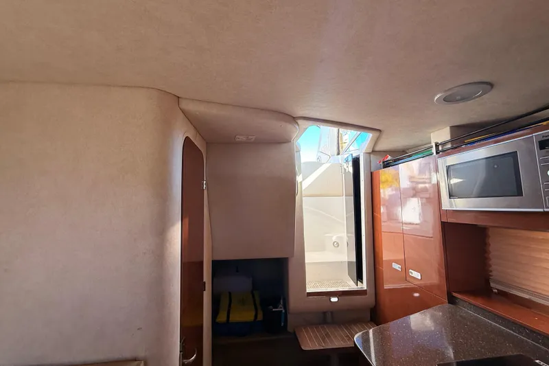 Slide: The Image of Interior of 2012 Sea Ray 310 Sundancer with microwave and cabinetry. - 64