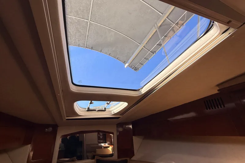 Slide: The Image of Interior view of 2012 Sea Ray 310 Sundancer with open sunroof. - 75