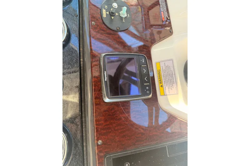 Slide: The Image of Control panel of 2012 Sea Ray 310 Sundancer with Raymarine display and warning label. - 81