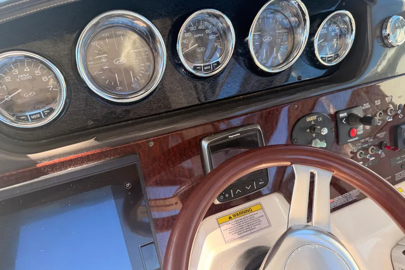Slide: The Image of Dashboard of 2012 Sea Ray 310 Sundancer with gauges and controls. - 82