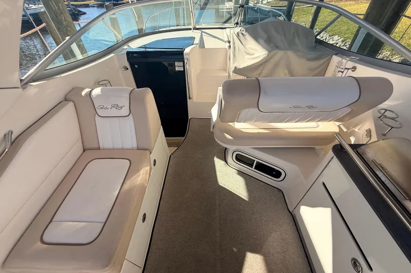 Slide: The Image of Interior of a 2012 Sea Ray 310 Sundancer boat with cushioned seating. - 86