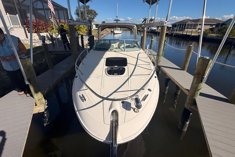 Slide: The Image of 2012 Sea Ray 310 Sundancer docked in a sunny marina setting. - 96
