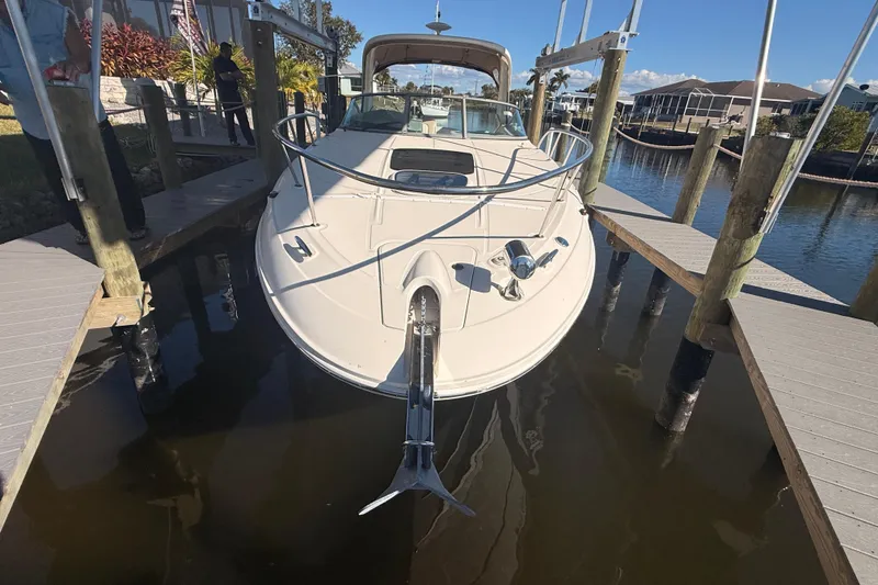 Slide: The Image of 2012 Sea Ray 310 Sundancer docked at marina, front view. - 97
