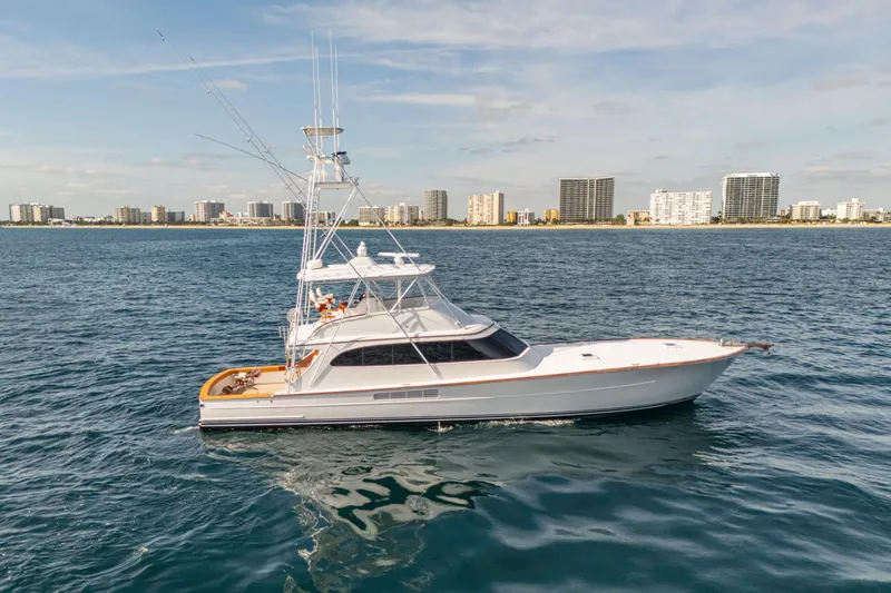 The Image of 2007 Merritt 72' Sportfish Convertible yacht cruising near city skyline. - 0
