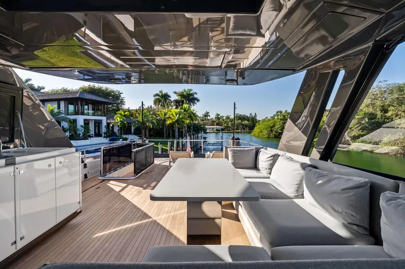 Slide: The Image of Luxurious 2019 Ferretti Yachts 780 interior with elegant seating and scenic waterfront view. - 18