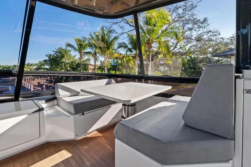 Slide: The Image of Luxurious 2019 Ferretti Yachts 780 interior with seating and table, surrounded by tropical scenery. - 20