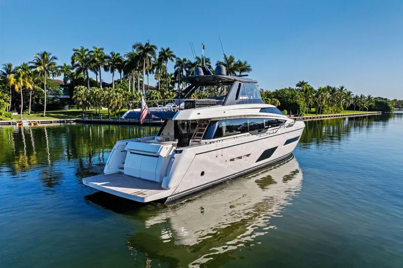 Slide: The Image of 2019 Ferretti Yachts 780 cruising on a serene, palm-lined waterway. - 4