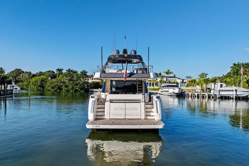 Slide: The Image of 2019 Ferretti Yachts 780 docked in a serene marina setting. - 8