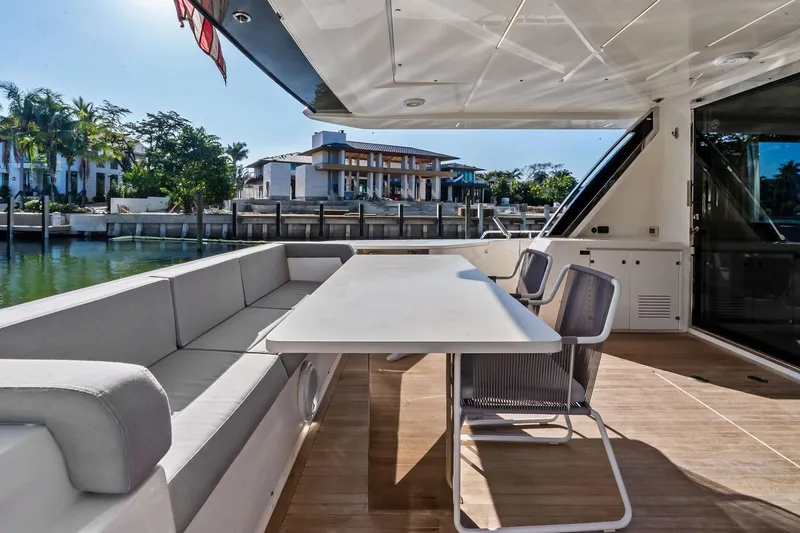 Slide: The Image of Luxurious outdoor seating on 2019 Ferretti Yachts 780, docked by waterfront homes. - 10