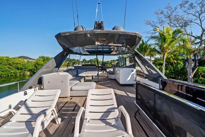 Slide: The Image of Luxurious 2019 Ferretti Yachts 780 deck with lounge chairs and tropical backdrop. - 15