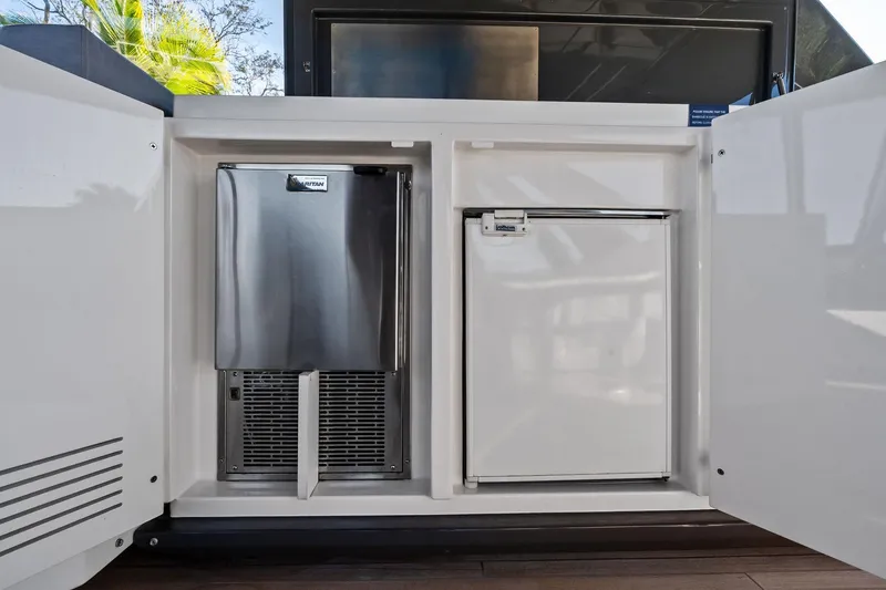 Slide: The Image of Built-in fridge and ice maker on 2019 Ferretti Yachts 780, open cabinet view. - 17