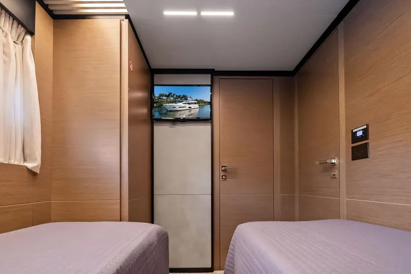 Slide: The Image of Interior of 2019 Ferretti Yachts 780, featuring twin beds and a wall-mounted TV. - 47
