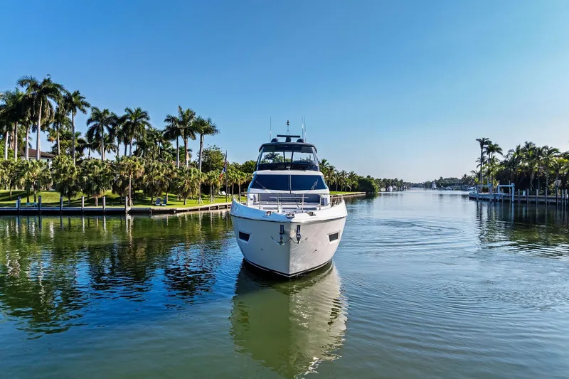 Slide: The Image of 2019 Ferretti Yachts 780 cruising on a serene, palm-lined waterway. - 5
