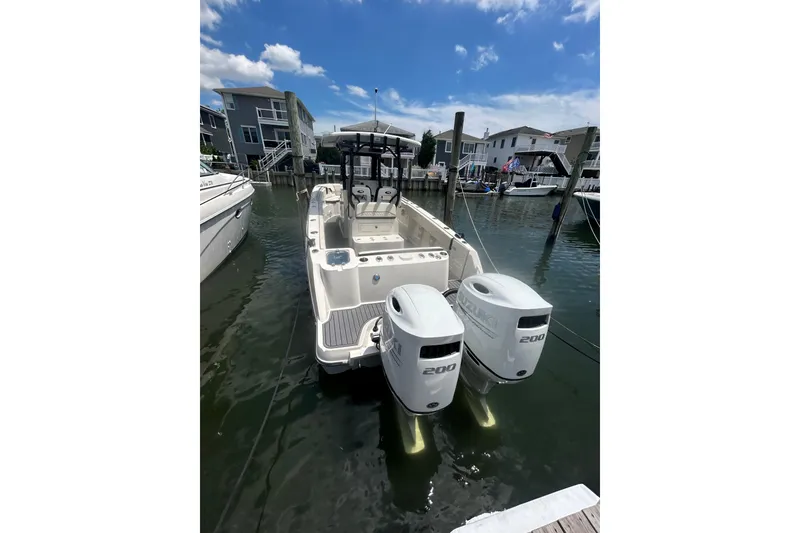 Slide: The Image of 2024 Stingray 273 CC boat docked with dual Suzuki 200 engines. - 3
