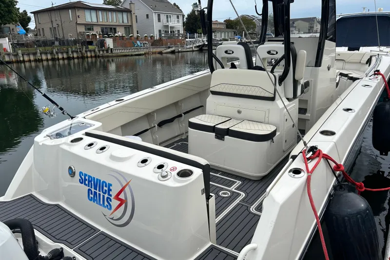 Slide: The Image of 2024 Stingray 273 CC boat docked, featuring spacious seating and "Service Calls" branding. - 4