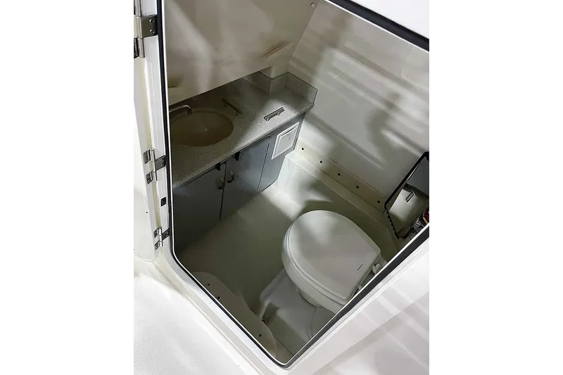 Slide: The Image of Manufacturer Provided Image: 2024 Stingray 273 CC boat interior bathroom with sink and toilet. - 6