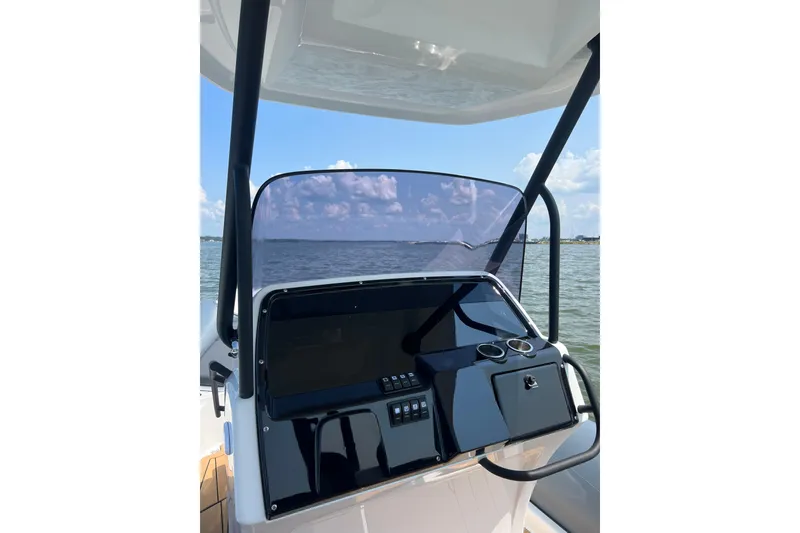 Slide: The Image of 2025 Grand Inflatables G850 boat console with ocean view, featuring modern controls and cup holders. - 10