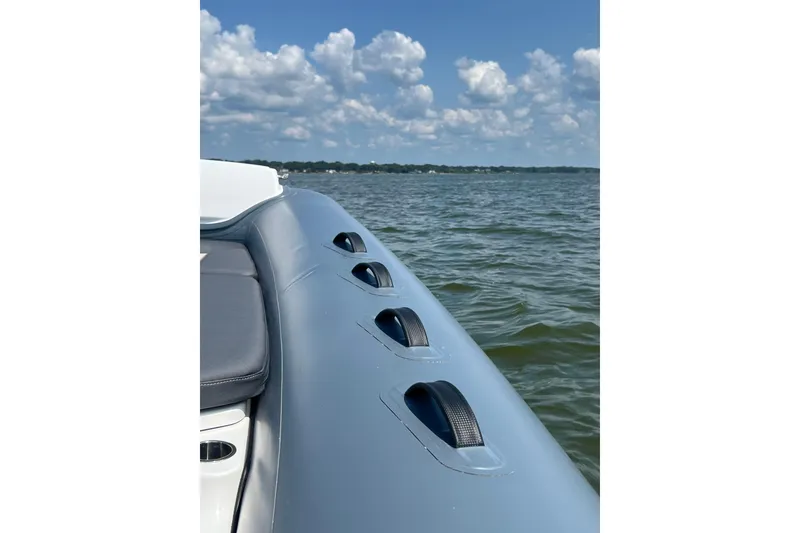 Slide: The Image of 2025 Grand Inflatables G850 boat on water under blue sky. - 13