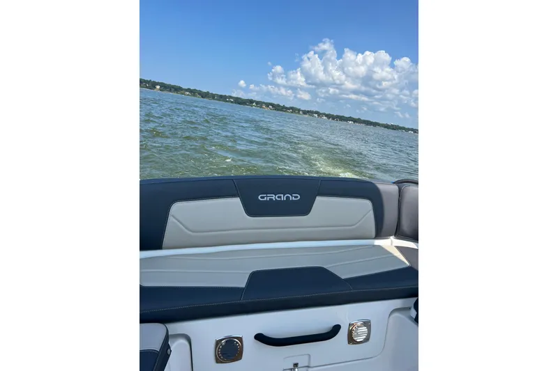 Slide: The Image of 2025 Grand Inflatables G850 boat on a lake with clear skies. - 16