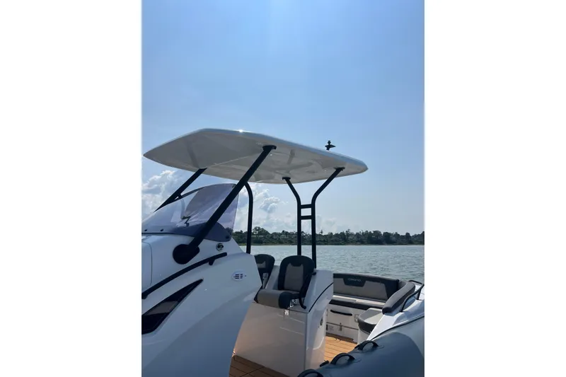 Slide: The Image of 2025 Grand Inflatables G850 boat with canopy on a sunny day, near a calm lake. - 8