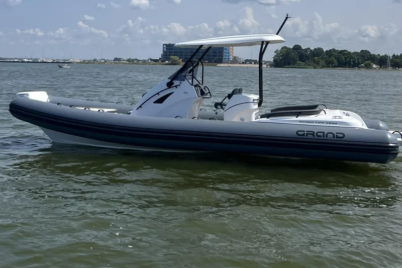 The Image of 2025 Grand Inflatables G850 boat on calm water under a clear sky. - 0