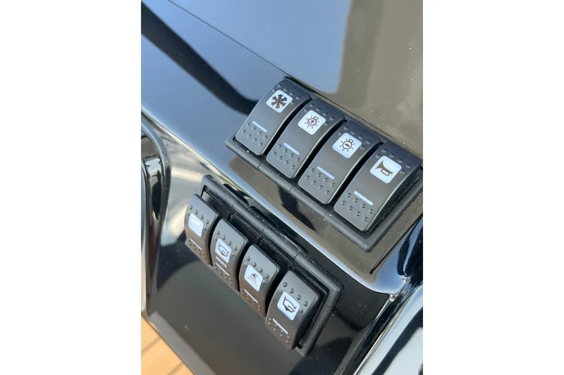 Slide: The Image of Control panel of 2025 Grand Inflatables G850 boat with various switches. - 12
