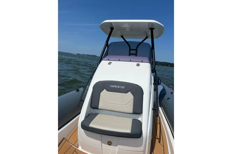 Slide: The Image of 2025 Grand Inflatables G850 boat on water, featuring sleek seating and modern design. - 14