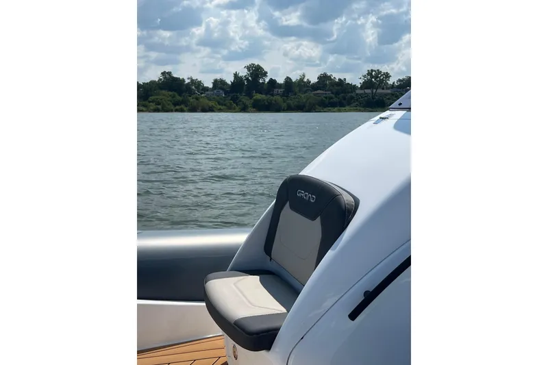 Slide: The Image of 2025 Grand Inflatables G850 boat seat with scenic water view. - 6