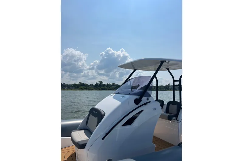 Slide: The Image of 2025 Grand Inflatables G850 boat on water under clear sky. - 7