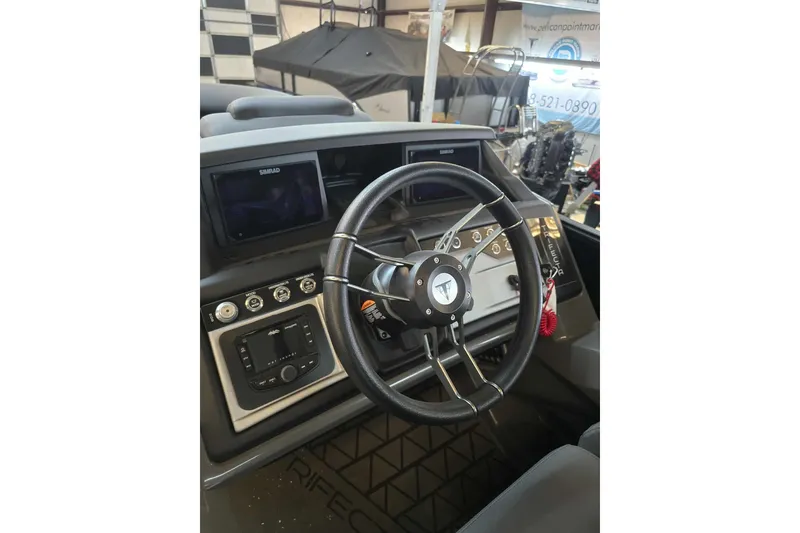 Slide: The Image of 2026 Trifecta SS 25RF boat dashboard with steering wheel and control panel. - 10