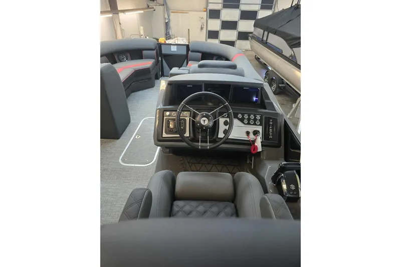Slide: The Image of 2026 Trifecta SS 25RF boat interior with modern steering and seating. - 11