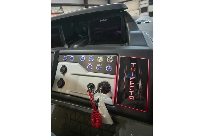 Slide: The Image of Dashboard of 2026 Trifecta SS 25RF boat with control panel and branding. - 13