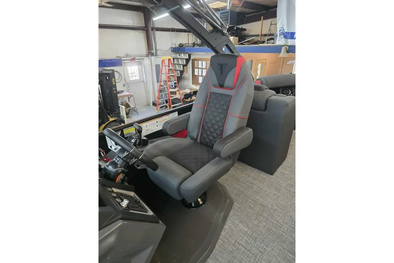 Slide: The Image of Captain's chair in 2026 Trifecta SS 25RF boat, featuring sleek design and modern controls. - 14